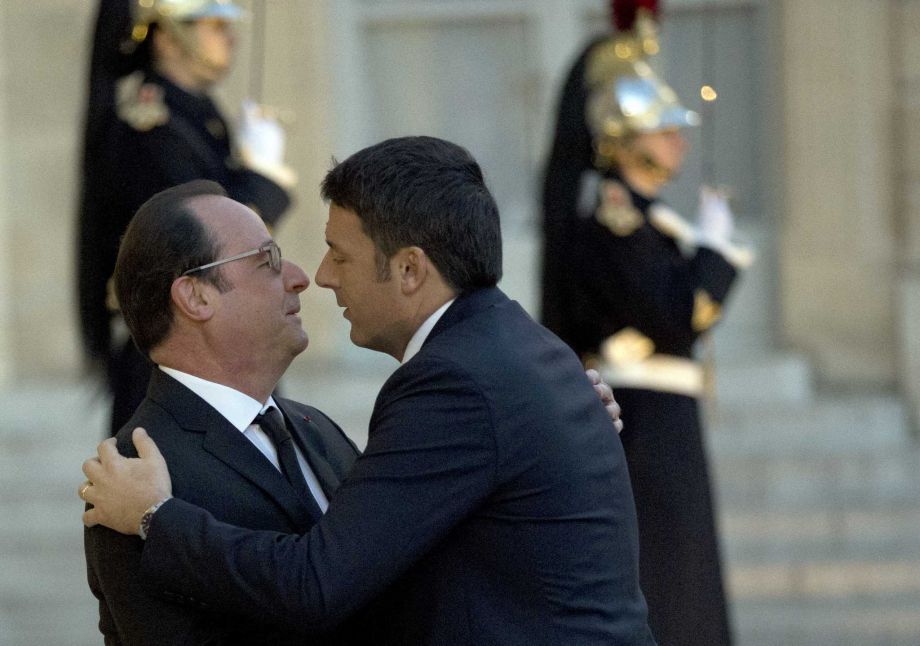 France's President Francois Hollande left greets Italian Premier Matteo Renzi prior to their meeting at the Elysee Palace in Paris Thursday Nov. 26 2015. Renzi's visit to Paris is part of president Hollande's diplomatic offensive to get the internati