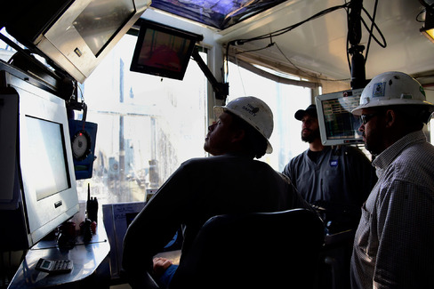 Contractors work in the control room at an Anadarko Petroleum Corp. oil rig site in Fort Lupton Colorado on Aug. 12 2014