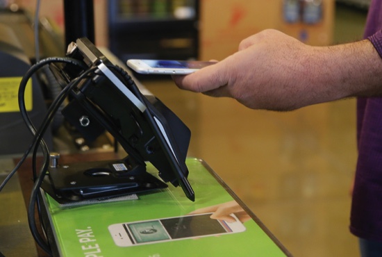 Eddy Cue Apple Senior Vice President of Internet Software and Services demonstrates the new Apple Pay mobile payment system at a Whole Foods store in Cupertino Calif