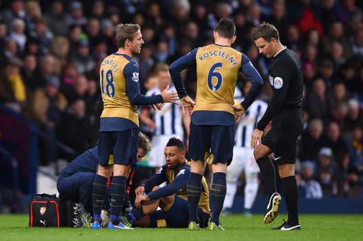 Arsenal's Francis Coquelin receives treatment before leaving match against West Brom with a knee injury