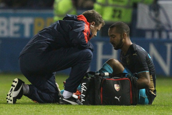 AFP  Lindesy ParnabyArsenal's striker Theo Walcott recieves treatment following a heavy tackle during an English League Cup fourth round football match against Sheffield Wednesday at The Hillsborough Stadium in Sheffield north east England on Octob