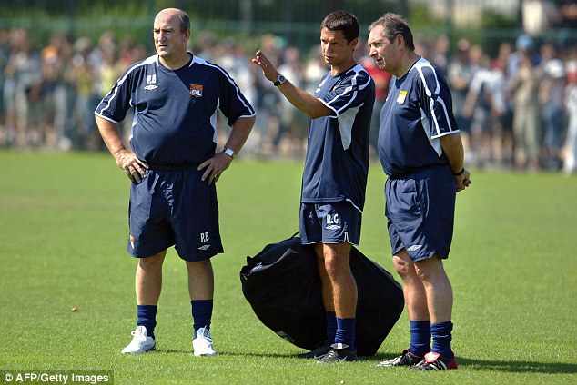 Assistant Remi Garde makes a point to then Lyon manager Gerard Houllier in June 2005