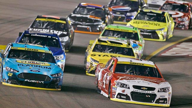 Kevin Harvick leads Joey Logano and the rest of the field into Turn 1 during the NASCAR Sprint Cup Series auto race at Phoenix International Raceway. AP