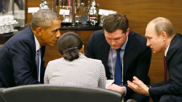 U.S. President Barack Obama talks with Russian President Vladimir Putin prior to the opening session of the G20 Leaders summit