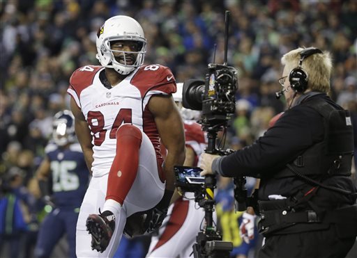 Arizona Cardinals tight end Jermaine Gresham holds the football behind his back as a television camera records his celebration after his touchdown reception against the Seattle Seahawks during the second half of an NFL football game Sunday Nov. 15 2015