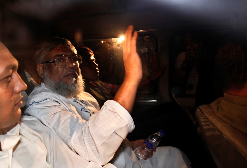 Ali Ahsan Mohammad Mujahid waves from a car as police arrest him in Dhaka in this file