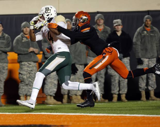 Baylor's Jay Lee catches a touchdown pass as OSU's Ashton Lampkin defends last Saturday