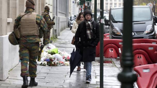 Belgian army soldiers patrol next to flowers left outside the French consulates&#039 office in Brussels