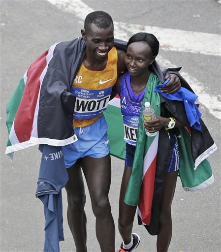 New York City Marathon winners Stanley Biwott left and Mary together after finishing, both from Kenya hug at the finish line in New York Sunday Nov. 1 2015