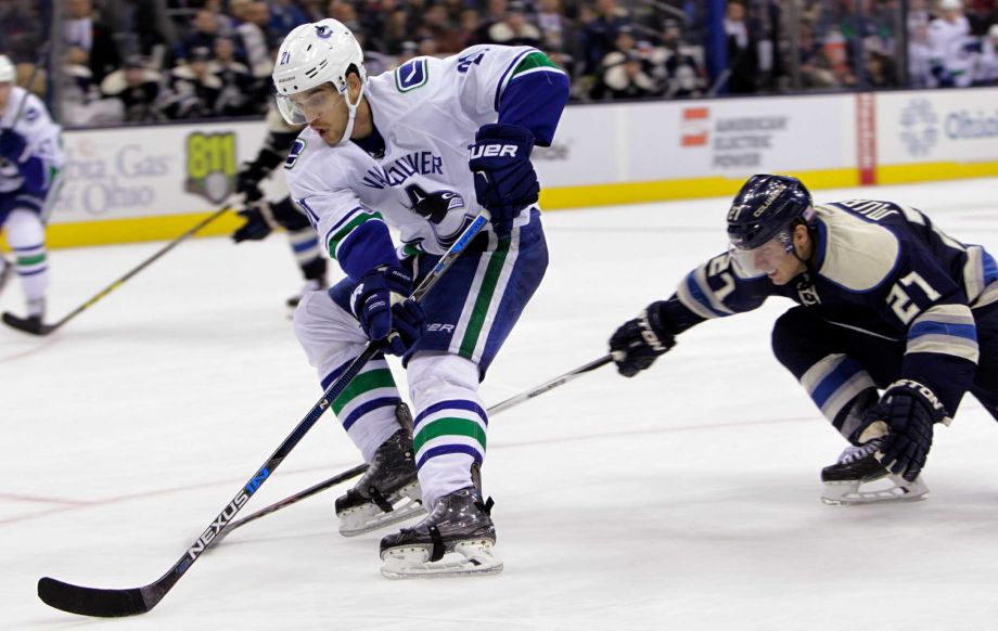 Vancouver Canucks Brandon Sutter left skates past Columbus Blue Jackets Ryan Murray to score a breakaway goal during the third period of an NHL hockey game Tuesday Nov. 10 2015 in Columbus Ohio. The Canucks beat the Blue Jackets 5-3