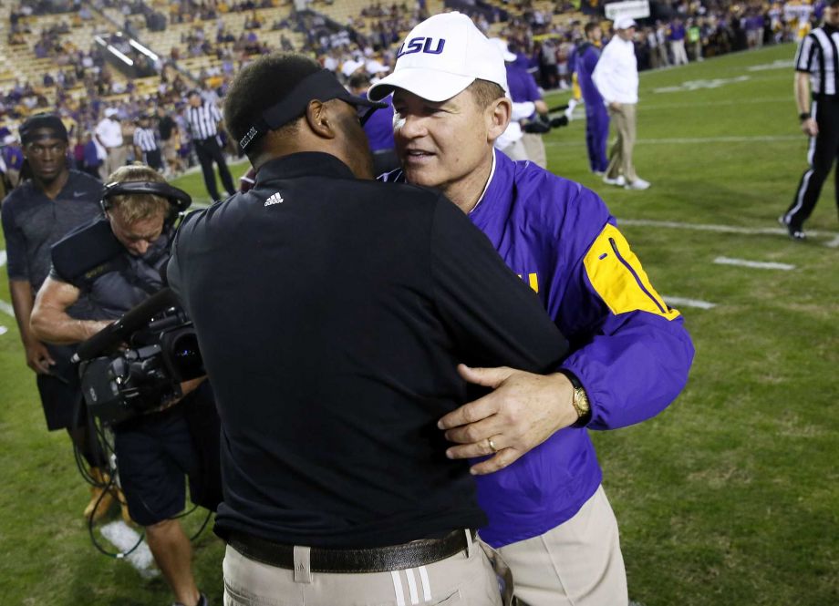 LSU head coach Les Miles greets Texas A&M head coach Kevin Sumlin before an NCAA college football game in Baton Rouge La. Saturday Nov. 28 2015