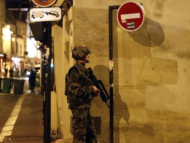 French security rush as people are evacuated in the area of Rue Bichat in the 10th arrondissement of Paris following a string of attacks