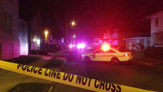 Police block off an area after a fatal shooting on Monday Nov. 23 2015 in Columbus Ohio. The suspect was shot by officers after a short chase outside the house where the shootings happened Columbus police said