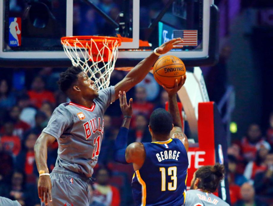 Chicago Bulls guard Jimmy Butler blocks a shot by Indiana Pacers forward Paul George during the first half of an NBA basketball game in Chicago on Monday Nov. 16 2015