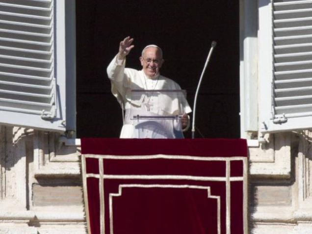 Pope Francis waves as he arrives to deliver the Angelus noon prayer from his studio window overlooking St. Peter's Square at the Vatican on Sunday. Two Italian journalists who wrote books on Vatican's mismanagement go on trial on Tuesday in the Vatican