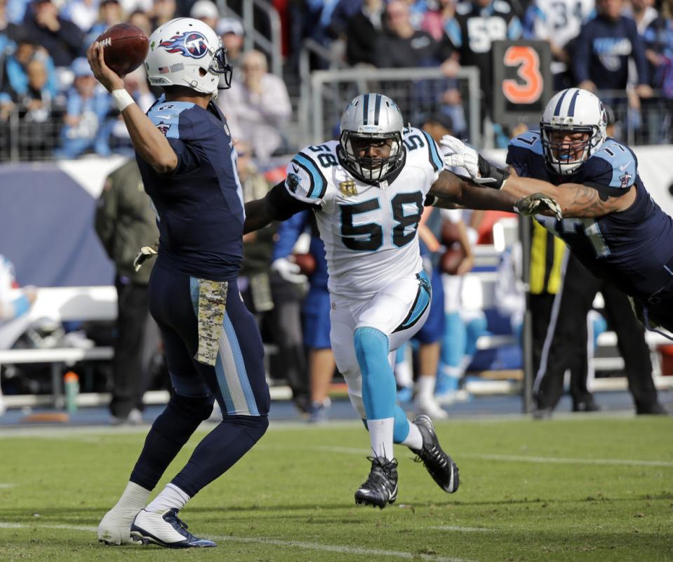 Carolina Panthers outside linebacker Thomas Davis gets past Tennessee Titans tackle Taylor Lewan as quarterback Marcus Mariota left passes in the second half of an NFL football game Sunday Nov. 15 2015 in Nashville Tenn. (AP