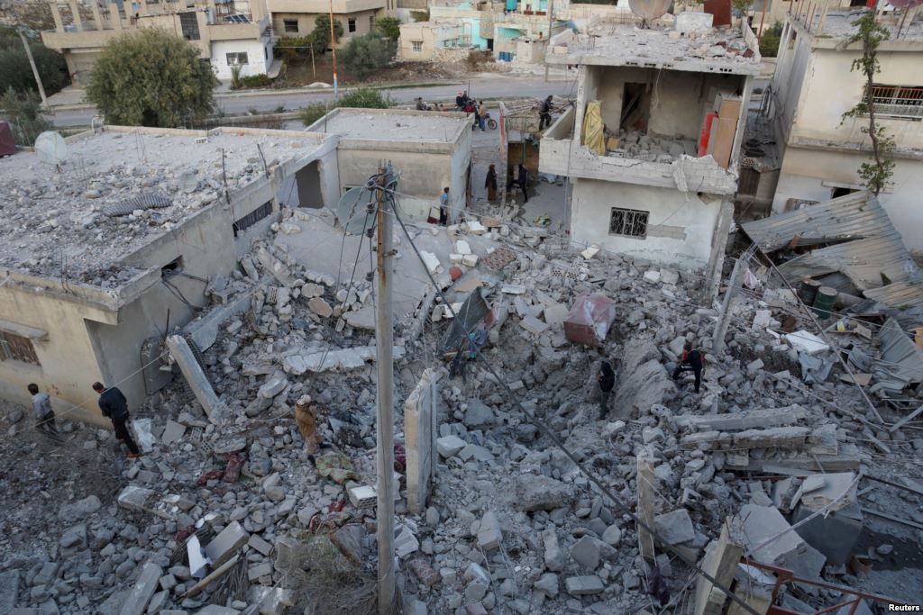 FILE- Residents inspect a damaged site from what activists said were airstrikes carried out by the Russian air force in Nawa city Deraa Syria Nov. 21 2015