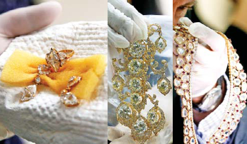 A Bureau of Customs appraiser shows to the media a set of jewelry from Roumeliotes Collection one of three sets of the Marcos Jewelry Collection during appraisal at the Central Bank of the Philippines Tuesday in Manila Philippines