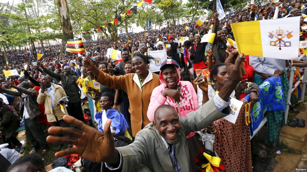 Catholic devotees wait for Pope Francis to arrive to lead a mass in Kampala Uganda