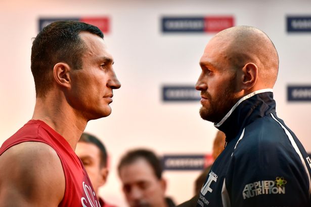 Challenger Tyson Fury watches world champion Wladimir Klitschko left after the Official Weigh In in Essen Germany