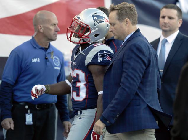 Patriots running back Dion Lewis leaves the field after an injury vs. Washington