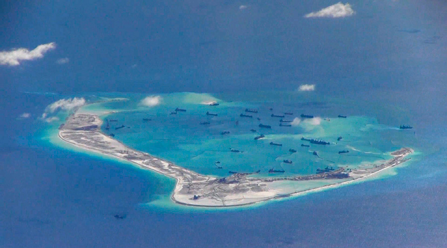 Chinese dredging vessels are purportedly seen in the waters around Mischief Reef in the disputed Spratly Islands in the South China Sea in this still image from video taken by a P-8A Poseidon surveillance aircraft