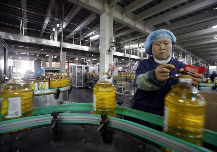 3 2015 shows a Chinese worker checking items on a production line at a cooking oil factory in Wuhan central China's Hubei province. China on November 3 sent its clearest signal yet that the world's second-largest economy