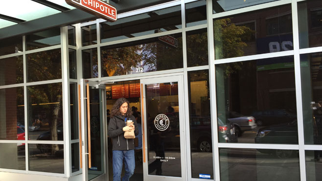 A customer leaves a Chipotle restaurant in Seattle as the company started to reopen the outlets closed because of an E. coli outbreak in the Pacific Northwest Wednesday Nov. 11 2015