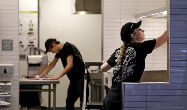 Workers clean inside a still-closed Chipotle restaurant Monday Nov. 9 in Seattle. Health officials in Washington and Oregon have said that more than three dozen people have gotten sick with E. coli in an outbreak linked to Chipotle restaurants in the