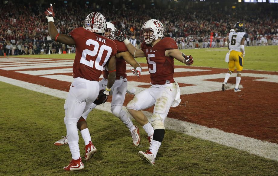 Stanford's Bryce Love 20 is greeted in the end zone after his long touchdown run in the fourth quarter by teammates Christian McCaffrey,5 and Rollins Stallworth 13 as Stanford beats California 35-22 in the 118th Big Game at Stanford Stadium on Sat. No