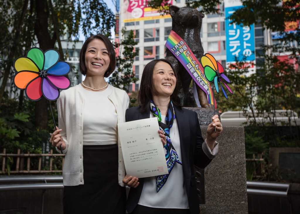 TOKYO JAPAN- NOVEMBER 05 Japanese couple Koyuki Higashi and Hiroko Masuhara celebrate as hold up their same-sex marriage certificate in front of Shibuya's Hachiko statue