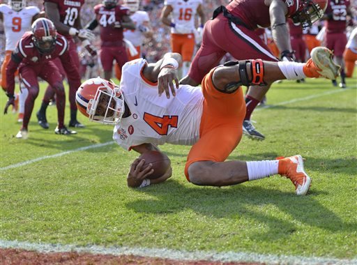 Clemson quarterback Deshaun Watson tumbles into the endzone for a 5-yard touchdown run during the first half of an NCAA college football game against South Carolina Saturday Nov. 28 2015 in Columbia S.C