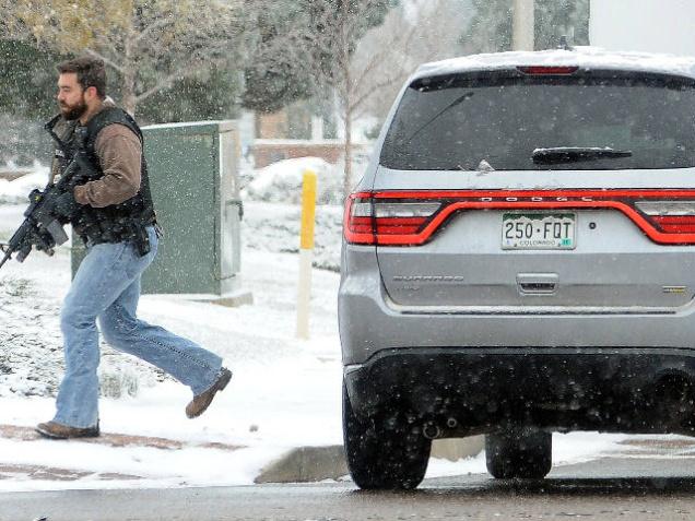 A law enforcement officer secures a perimeter near the deadly shooting at Planned Parenthood in Colorado