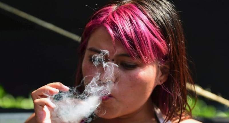 A woman smokes marijuana during a rally in front of the Supreme Court of Justice in Mexico City on Nov. 4 2015