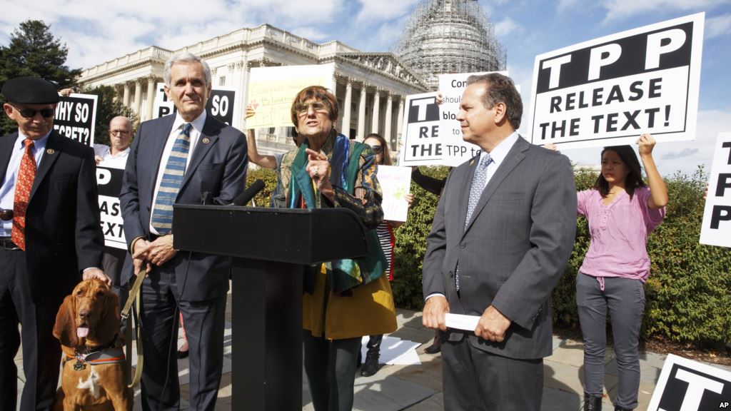 FILE- Rep. Rosa DeLauro center joined at left by Rep. Lloyd Doggett a bloodhound named Roxy Rep. David Cicilline and other members of Congress speaks at a news conference on Capitol Hill in Washington Oct. 29 2015 about the details of the TPP