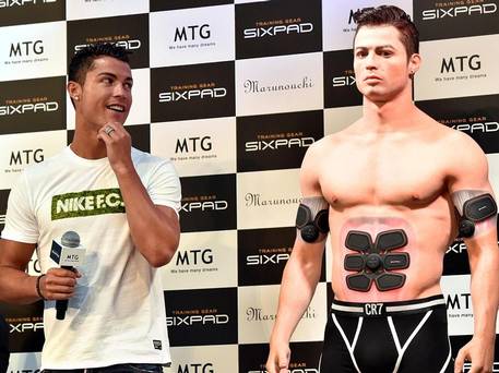 Cristiano Ronaldo casts an eye over his lookalike figure made by a 3D printer during a promotional event in Tokyo in July Getty Images