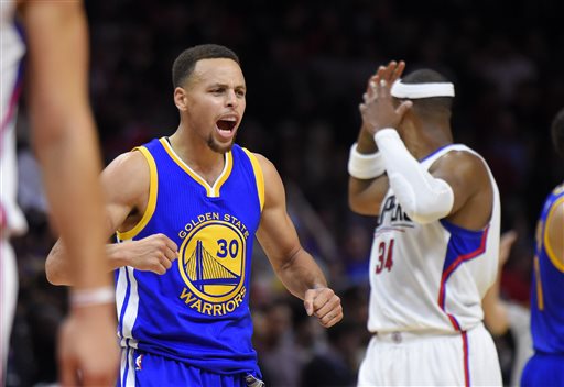 Golden State Warriors guard Stephen Curry left celebrates near Los Angeles Clippers forward Paul Pierce during the second half Thursday in Los Angeles. The Warriors won 124-117