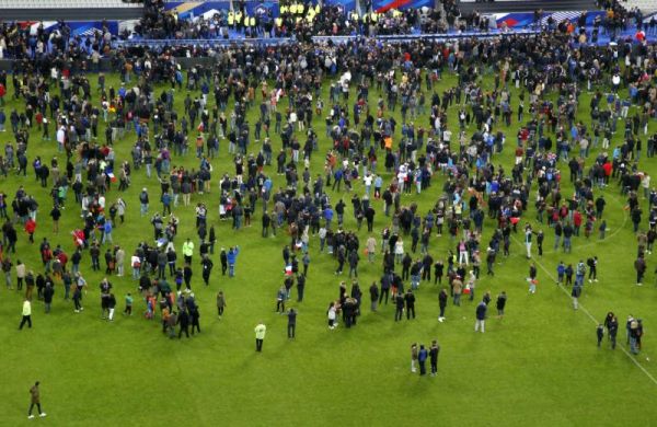 Spectators invade the pitch of the Stade