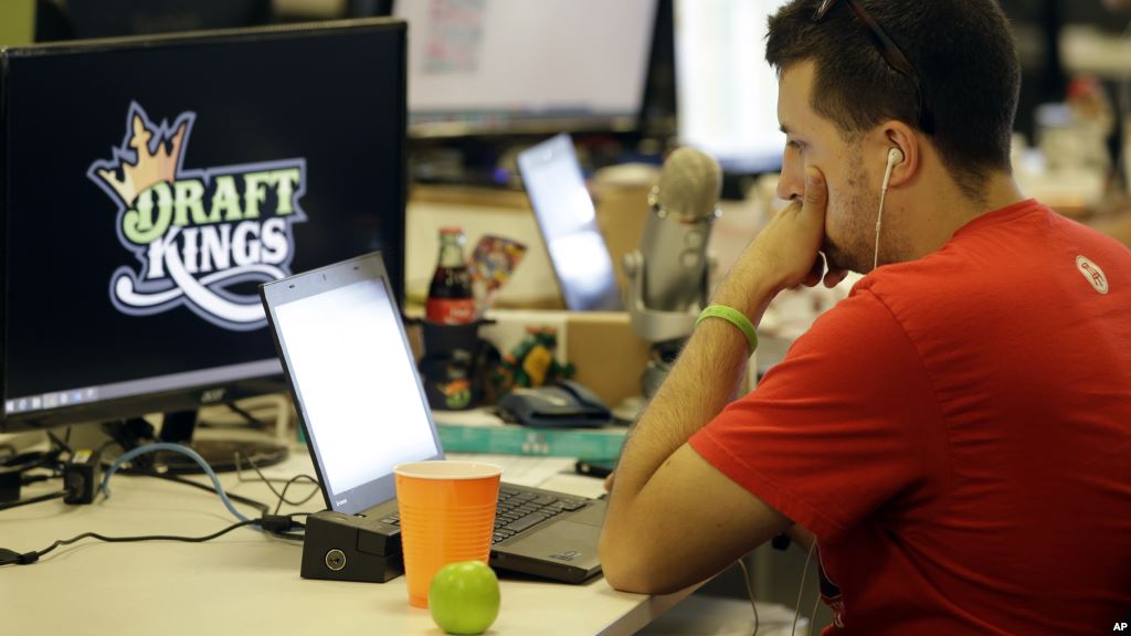 FILE- An employee at DraftKings a fantasy sports company is seen working on his laptop at the company's offices in Boston Massachusetts Sept. 9 2015