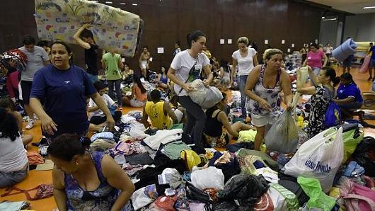 People gather at the Arena Mariana in Mariana after a dam broke in the locality of Bento Rodrigues