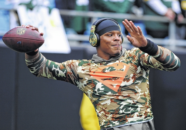 Dannie Walls|Daily Journal Carolina Panthers quarterback Cam Newton pulled down a banner supporting the Green Bay Packers before Sunday’s game