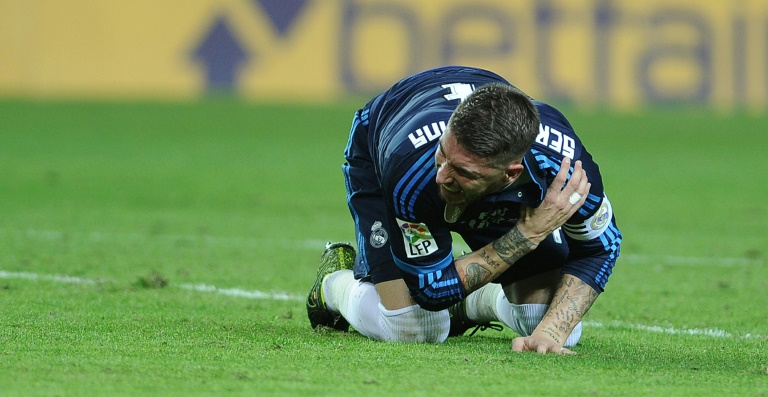 AFP  File  Cristina Quicler Real Madrid's defender Sergio Ramos reacts to an injury after scoring during a Spanish league football match against Sevilla at the Ramon Sanchez Pizjuan stadium in Sevilla