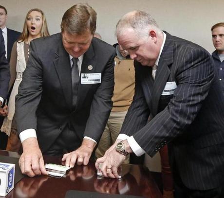 Representative Bo Eaton Democrat of Taylorsville, and Republican challenger Mark Tullos opened silver-plated business card boxes that held the long and short straws