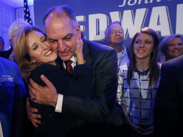 Louisiana Gov.-elect John Bel Edwards hugs his wife Donna Edwards as he arrives to greet supporters at his election night watch party in New Orleans Saturday Nov. 21 2015. At right is his daughter Sarah Ellen Edwards. Edwards won the runoff election