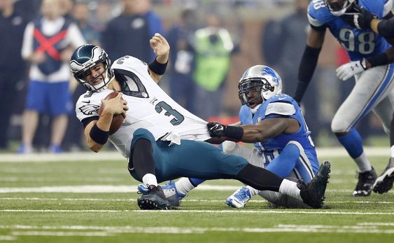 Mark Sanchez is sacked by Detroit Lions middle linebacker Stephen Tulloch during the second half of an NFL football game Thursday Nov. 26 2015 in Detroit