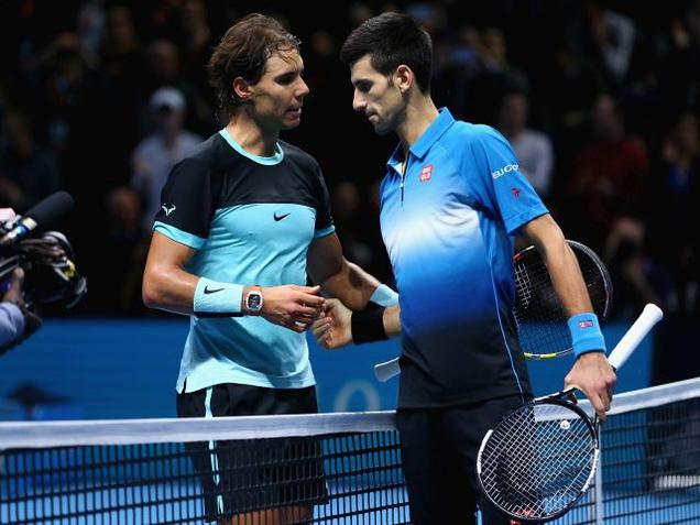 Novak Djokovic of Serbia shakes hands at the net after his straight sets victory against Rafael Nadal of Spain during the men's singles semi final match on day seven of the Barclays ATP World Tour Finals at O2 Arena