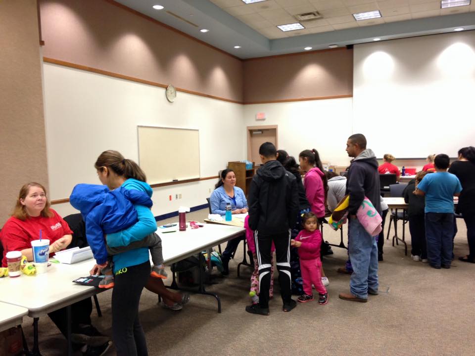 Dozens of families lined up to register to received toys this holiday season