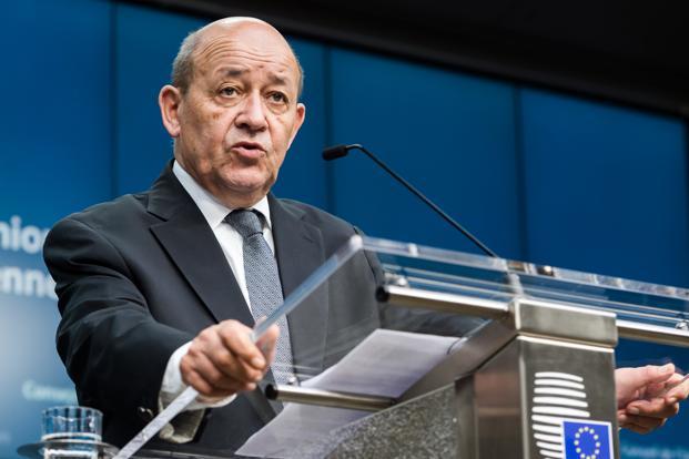 France’s Defense Minister Jean Yves Le Drian addresses the media during an EU foreign and defense ministers meeting at the EU Council building in Brussels on 17 November 2015