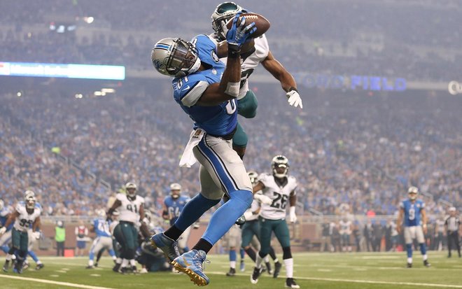 Detroit’s Calvin Johnson catches one of his three touchdown passes from Matthew Stafford on Thursday