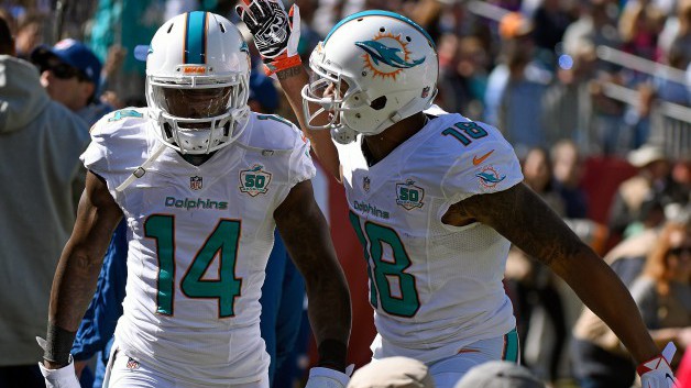 NASHVILLE TN- OCTOBER 18 Rishard Matthews #18 of the Miami Dolphins congratulates teammate Jarvis Landry #14 after scoring a touchdown against of the Tennessee Titans during the first half of a game at Nissan Stadium